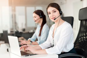 operator call center answers customer requests online phone modern company office 1024x684